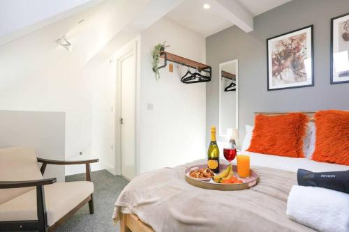 a room with a bed with a tray of food on it at Central Buckingham Apartment #3 with Free Parking, Pool Table, Fast Wifi and Smart TV with Netflix by Yoko Property in Buckingham