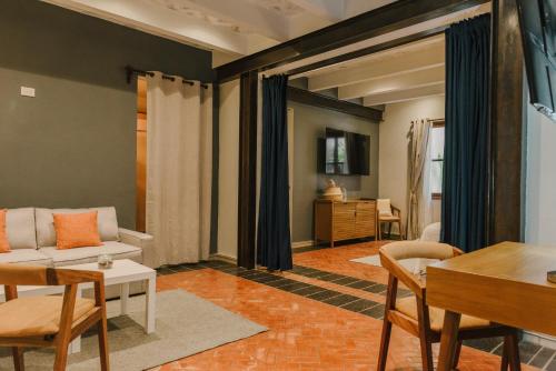 a living room with a couch and a table at Agua Santa Hotel Boutique in San Miguel de Allende
