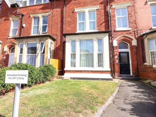 a sign in front of a brick house at The Hideaway - Perfect couples retreat with Free parking on driveway in Lytham St Annes