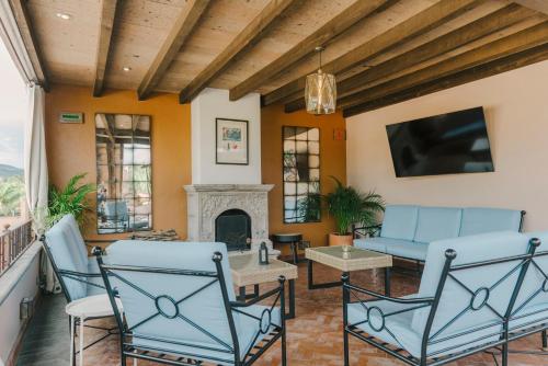 a living room with blue chairs and a fireplace at Agua Santa Hotel Boutique in San Miguel de Allende
