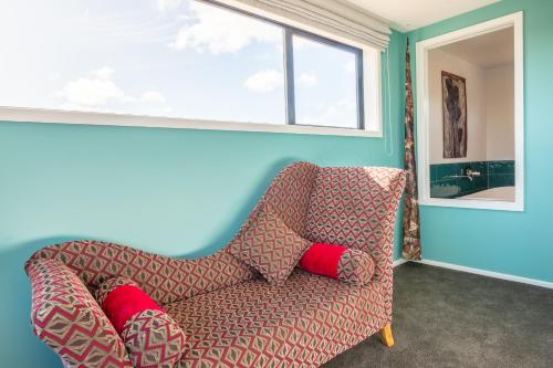 a living room with a couch and a window at Ono in Te Horo