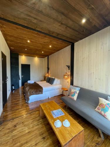 a large bedroom with a bed and a couch at Surf Lodge Punta de Lobos in Pichilemu