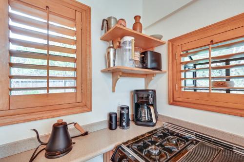 a kitchen with wooden cabinets and a stove top oven at Pet-Friendly Flagstaff Studio Cabin with Patio in Flagstaff