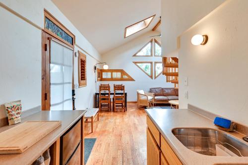 a kitchen with a sink and a living room at Pet Friendly Flagstaff Studio Cabin with Patio in Flagstaff