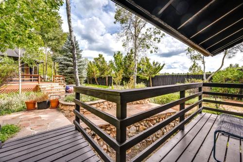 a wooden deck with a bench on top of it at Pet-Friendly Flagstaff Studio Cabin with Patio in Flagstaff