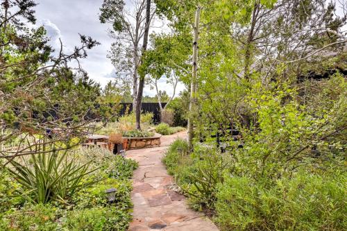 a path through a garden with benches and trees at Pet-Friendly Flagstaff Studio Cabin with Patio in Flagstaff