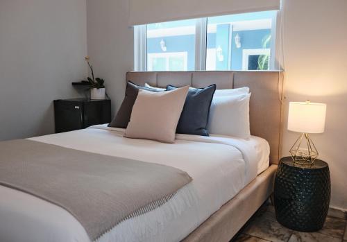 a bedroom with a large bed with a window at Coral Princess Hotel in San Juan