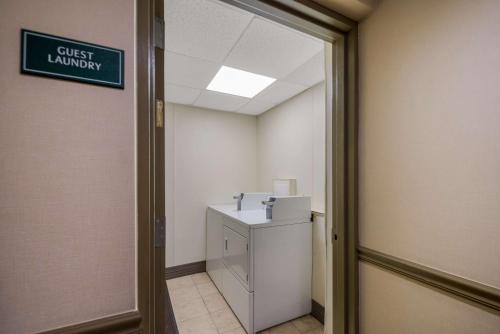 a hallway with a toilet and a sign on the wall at Best Western Philadelphia South - West Deptford Inn in Thorofare