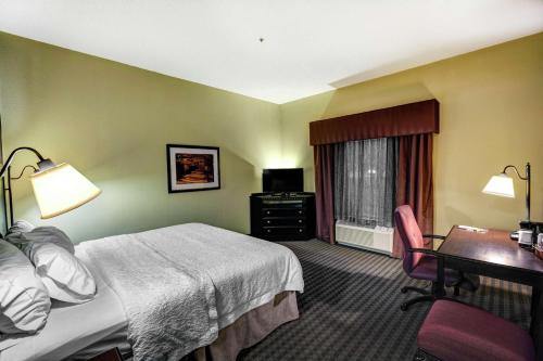 a hotel room with a bed and a desk at Hampton Inn & Suites Chadds Ford in Glen Mills