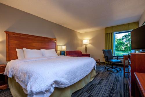 a hotel room with a large bed and a window at Hampton Inn Bowling Green KY in Bowling Green