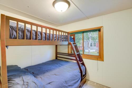 a bedroom with a bunk bed and a bunk ladder at Waterfront Wahkon Home with Wraparound Deck and Docks in Isle