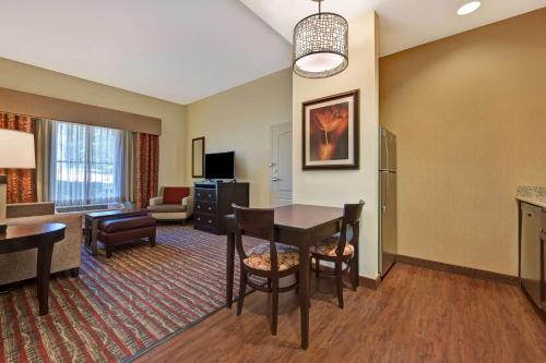 a living room with a table and a living room at Homewood Suites by Hilton Denver Tech Center in Englewood
