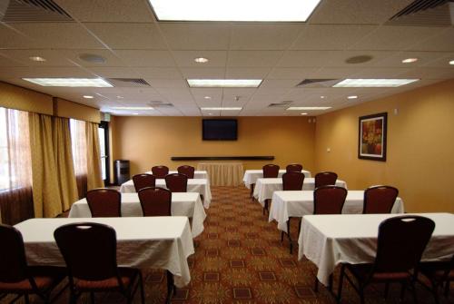 a conference room with white tables and chairs and a screen at Homewood Suites by Hilton Denver Tech Center in Englewood