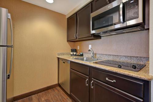 a kitchen with a sink and a microwave at Homewood Suites by Hilton Denver Tech Center in Englewood