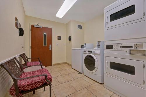 a laundry room with a washing machine and a washer at Homewood Suites by Hilton Denver Tech Center in Englewood