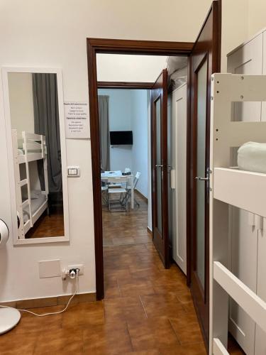 a hallway with a mirror and a room with a table at Appartamento vicino centro in Turin