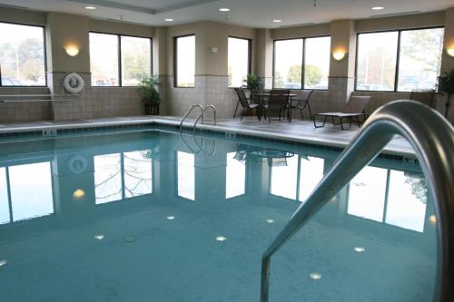 ein großer Pool in einem Gebäude mit Fenstern in der Unterkunft Hampton Inn & Suites Norfolk-Airport in Norfolk