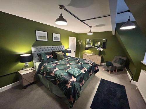 een slaapkamer met een bed en een groene muur bij The Green House Hythe in Kent