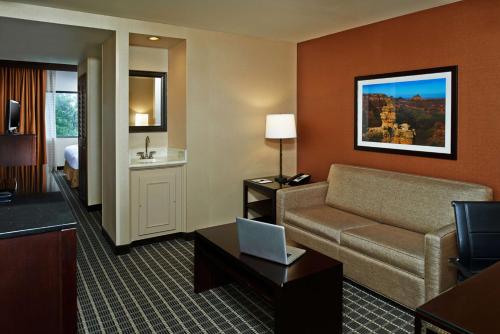 a hotel room with a couch and a bed at DoubleTree by Hilton Hotel Flagstaff in Flagstaff