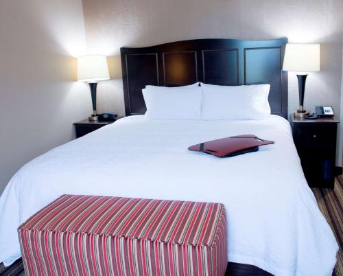 a large bed with a red and white blanket and two lamps at Hampton Inn and Suites Hope in Hope