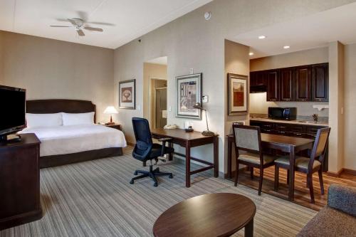 a hotel room with a bed and a desk at Homewood Suites by Hilton Burlington in Burlington