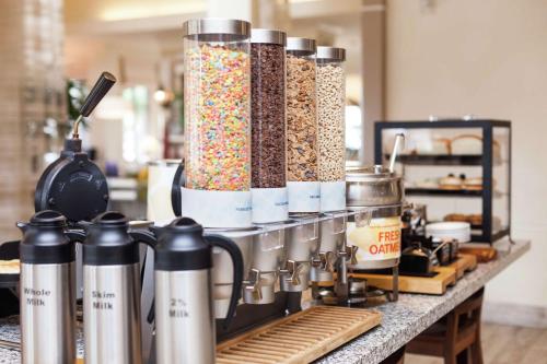 a counter with a bunch of different types of food at Hilton Garden Inn Palm Springs/Rancho Mirage in Rancho Mirage