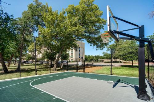 a basketball hoop in a park with trees at Hampton Inn & Suites Dallas/Plano-East in Plano