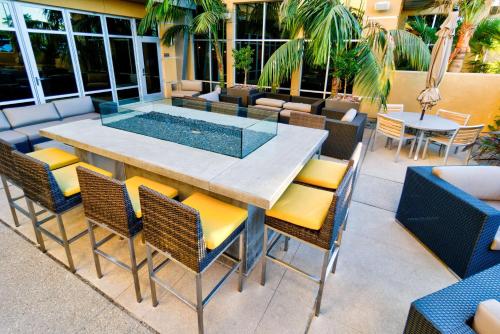 a patio with a table and chairs and a pool at Hilton Garden Inn Santa Barbara/Goleta in Santa Barbara