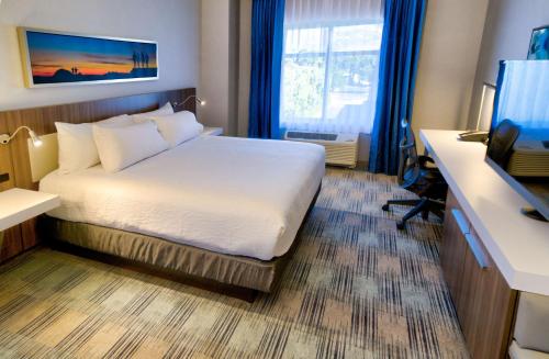 a hotel room with a bed and a desk and a television at Hilton Garden Inn Santa Barbara/Goleta in Santa Barbara