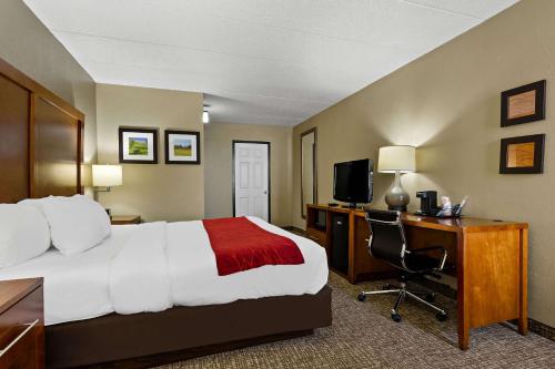 a hotel room with a bed and a desk and a computer at Comfort Inn Wytheville in Wytheville