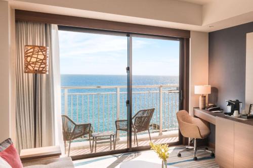 a living room with a view of the ocean at DoubleTree by Hilton Okinawa Chatan Resort in Chatan