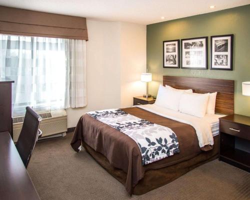 a hotel room with a bed and a window at Sleep Inn University Place in Charlotte