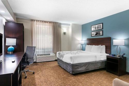 a hotel room with a bed and a desk at Sleep Inn Mount Pleasant - Charleston in Charleston