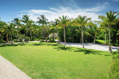 a large lawn with palm trees in a park at Baker's Cay Resort Key Largo, Curio Collection By Hilton in Key Largo