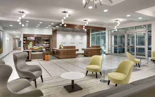 a lobby with chairs and tables and a waiting room at Hilton Garden Inn Lehi in Lehi