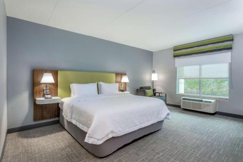 a large bedroom with a large bed and a window at Hampton Inn & Suites Saraland Mobile in Saraland