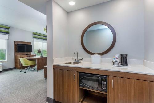 a bathroom with a sink and a mirror at Hampton Inn & Suites Saraland Mobile in Saraland