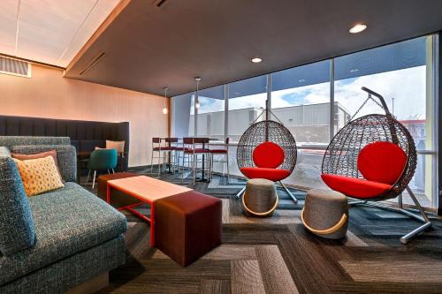 a room with two chairs and a couch and a table at Tru By Hilton Albuquerque North I-25, Nm in Albuquerque