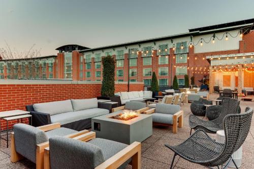 a patio with couches and chairs and a fire pit at The Chattanoogan Hotel, Curio Collection By Hilton in Chattanooga