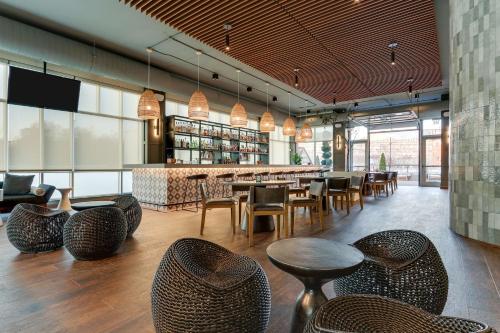 a restaurant with tables and chairs and a bar at The Chattanoogan Hotel, Curio Collection By Hilton in Chattanooga