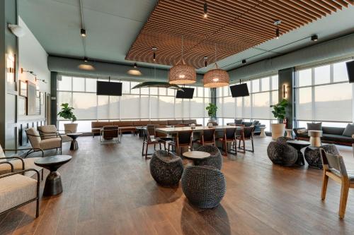 a large room with tables and chairs and windows at The Chattanoogan Hotel, Curio Collection By Hilton in Chattanooga