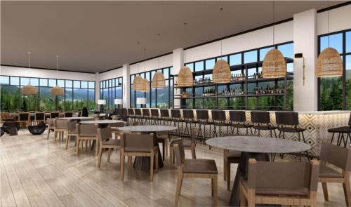 a restaurant with tables and chairs and windows at The Chattanoogan Hotel, Curio Collection By Hilton in Chattanooga