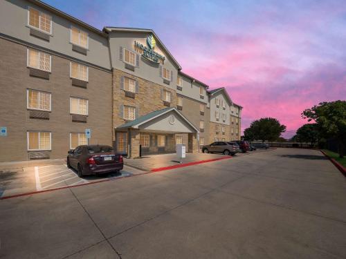 a rendering of a hotel with a parking lot at WoodSpring Suites Dallas Rockwall in Rockwall