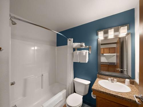 a bathroom with a white toilet and a sink at WoodSpring Suites Dallas Rockwall in Rockwall