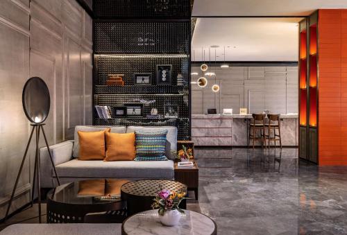 a living room with a couch and a table at Canopy by Hilton Hangzhou West Lake in Hangzhou