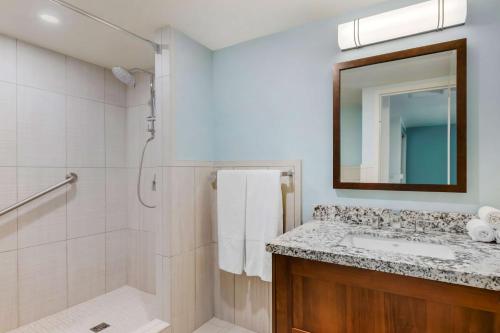 a bathroom with a shower and a sink and a mirror at Hilton Vacation Club Royal Palm St Maarten in Simpson Bay