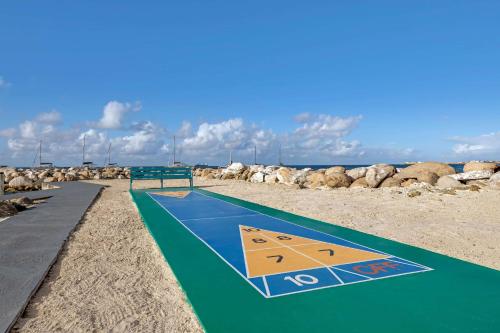 a volleyball court on a beach with rocks at Hilton Vacation Club Royal Palm St Maarten in Simpson Bay