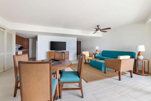 a living room with a table and a blue couch at Hilton Vacation Club Royal Palm St Maarten in Simpson Bay