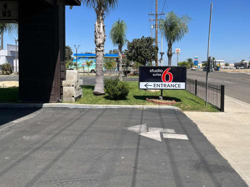 a sign on the side of a street at Studio 6 Suites Delano, CA in Delano