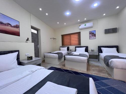 a bedroom with three beds and avisor at Z3 Hostel in Wadi Musa